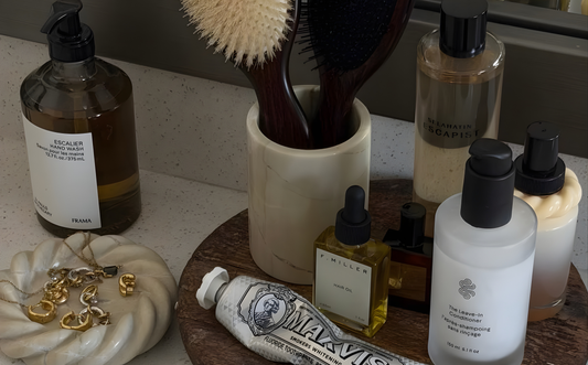 Collection of skincare and grooming products on a bathroom counter.