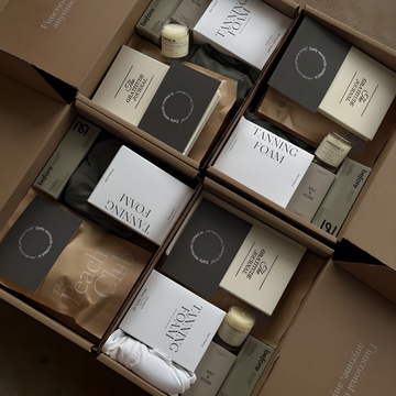 Open cardboard box containing various skincare products with visible branding.